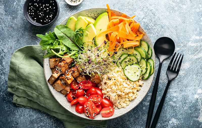 Colorful buddha bowl salad with tofu and vegetables